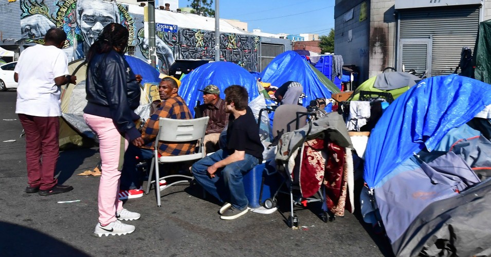 Homeless residents gather outside their tents on a sidewalk in Los Angeles, California on January 8, 2020. - California Governor Gavin Newsom said his state budget will include more than $1 billion directed towards homelessness, in response to a growing crisis on the streets on California's major cities. (Photo: Frederic J. Brown/AFP via Getty Images)